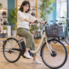 小柄な人が電動アシスト自転車に試乗して足つきとハンドル位置を確かめているイメージ