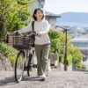 緩やかな坂道で電動自転車を押し歩く人